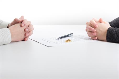divorcing couple about to sign papers in lawyer's office
